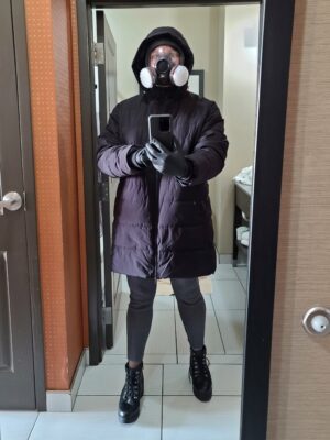 Mirror selfie in a hotel room. The temperature outside was bitterly cold, which led me to really bundle up. I jokingly referred to this look as "COVID snowbunny".