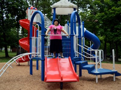 Jennifer in black tiered skirt and pink t-shirt, with black flats.