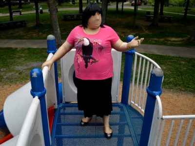 Jennifer in black tiered skirt and pink t-shirt, with black flats.