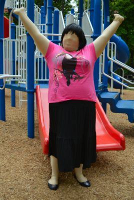 Jennifer in black tiered skirt and pink t-shirt, with black flats.