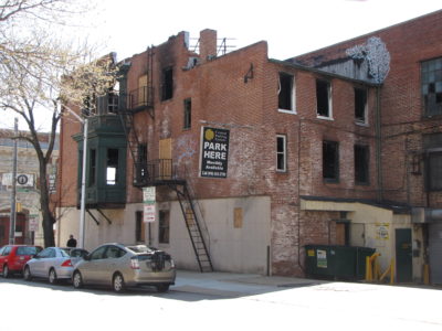 View from the northwest, showing the west (rear) side of the building.  Those who had been to the Play House may recall that the third floor was split, with a lower area in back, and the main dungeon area on that floor being higher up to accommodate the higher ceiling on the second floor.