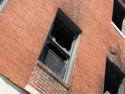 Middle window on the second floor, broken out like all of the other windows.