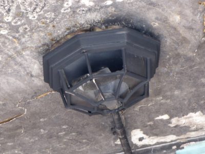 The porch light over the main entrance on Calvert Street.  It appears mostly intact following the fire, though it is probably irreparably damaged.