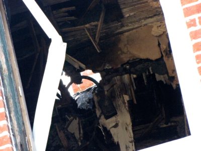 View through the far left window on the back of the building, showing the lower part of the third floor.